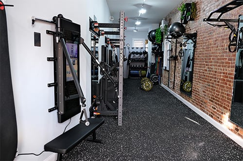 Rent a Rack section in a Genesis training, showcasing weightlifting racks and equipment available for rental, offering individuals hourly gym rental an opportunity for strength training and focused workouts.